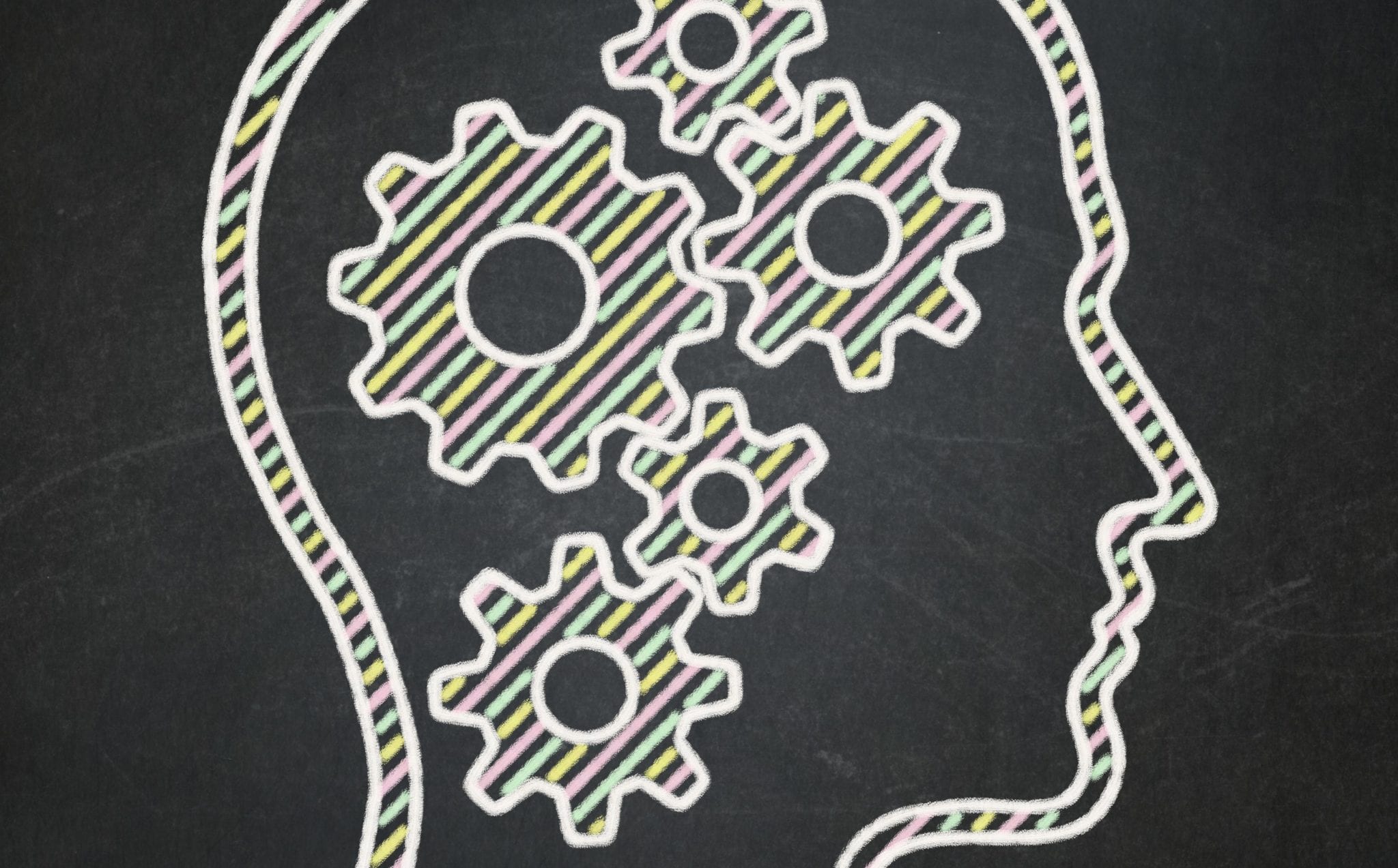 Outline of a human head in profile with several gears inside